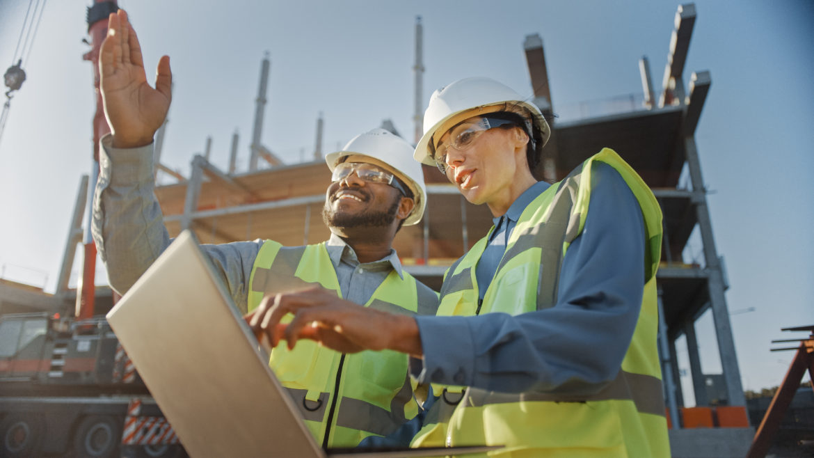 Two construction workers on a a construction site.